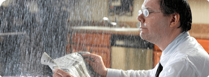 Water Leaks - Wet man reading newspaper