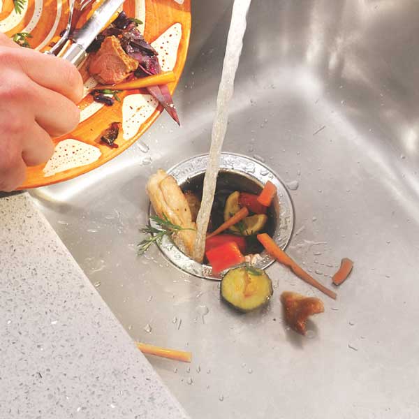 Putting food scraps down the sink waste - waste disposal