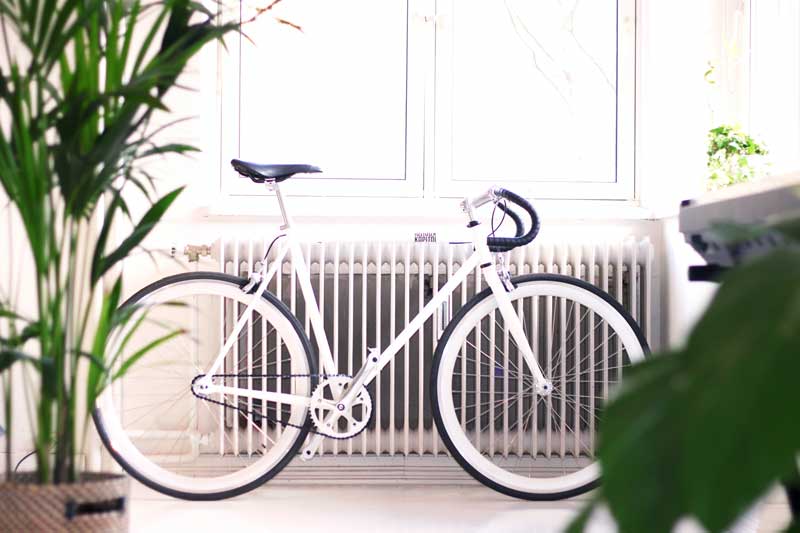 Modern column radiator with bike against it