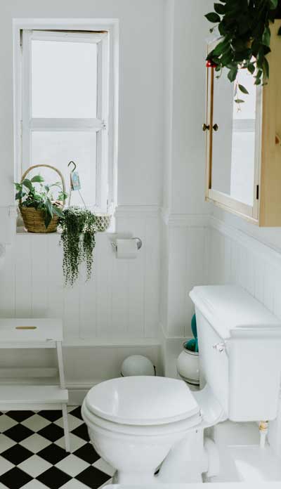 Toilet in a small bathroom with window